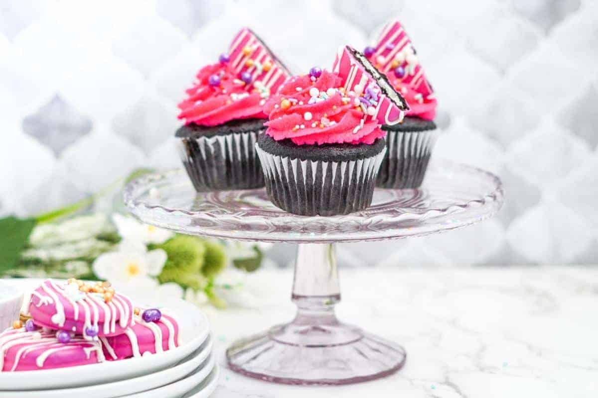 dark chocolate cupcakes with pink oreos